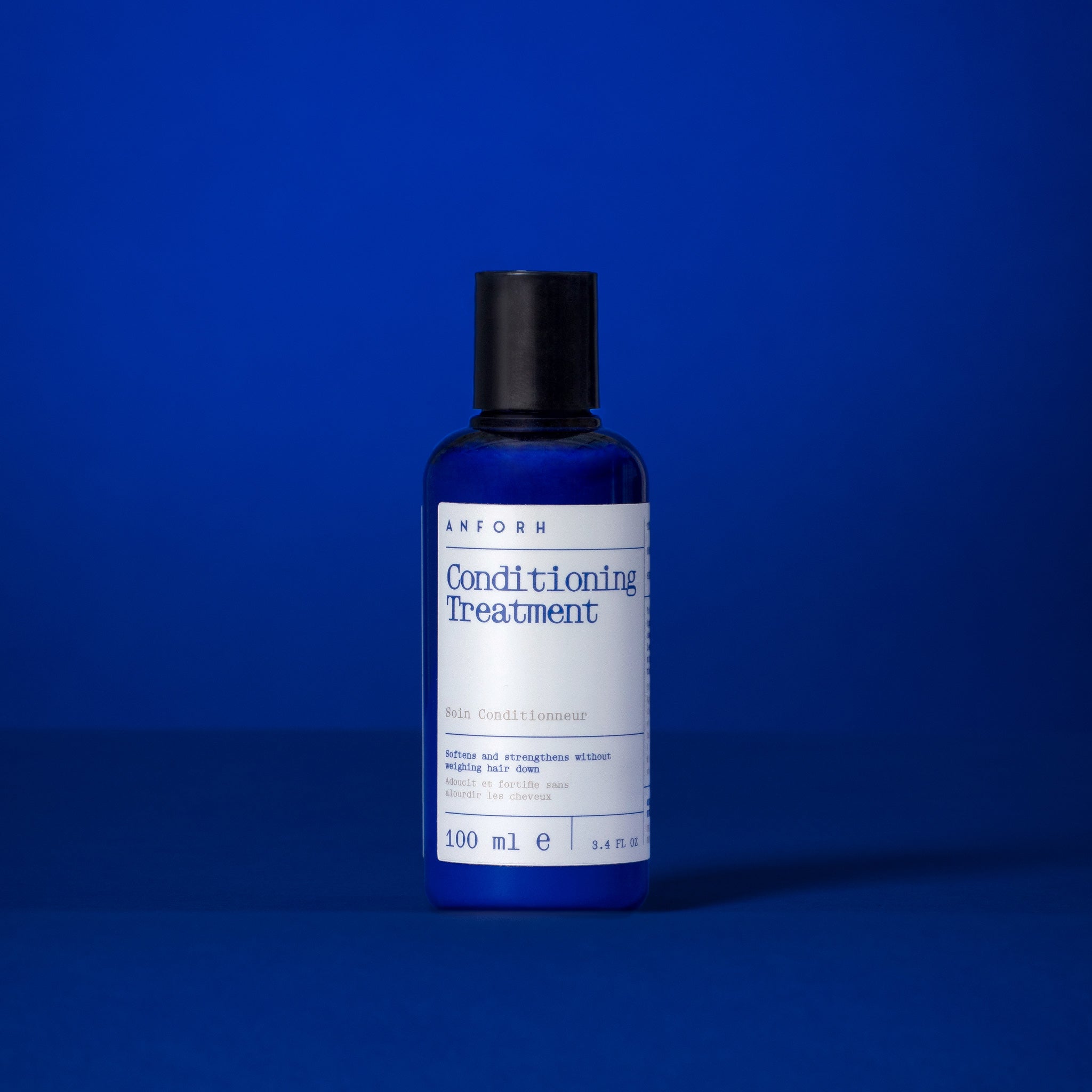Blue plastic bottle of Anforh Conditioning Treatment against a blue background