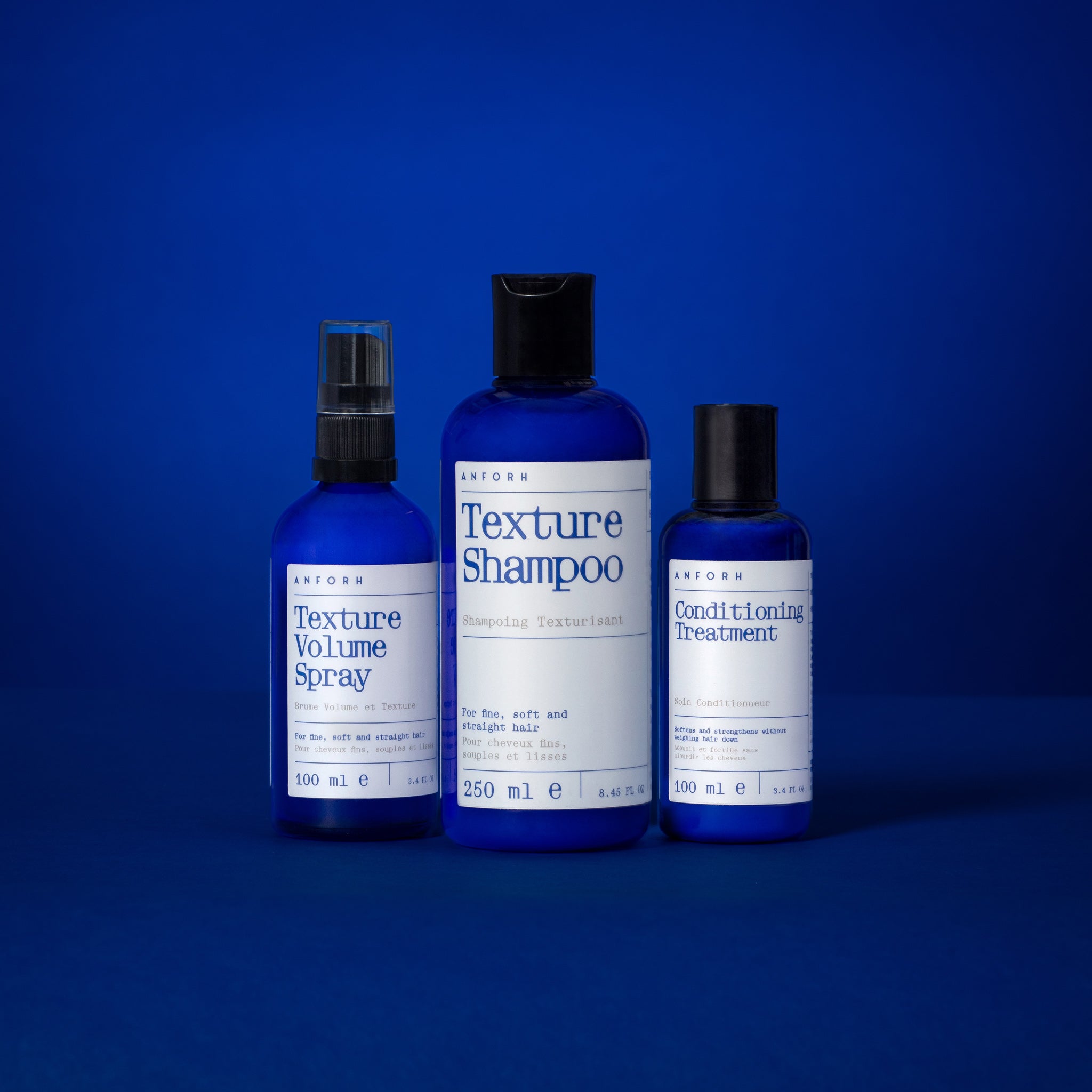 Anforh Texture Collection showing Texture Volume Spray, Texture Shampoo and Conditioning Treatment blue bottles against a blue background